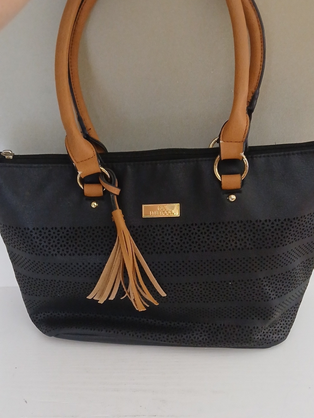 Minicci Black and Tan Women's Tote Bag with Tassel Accent